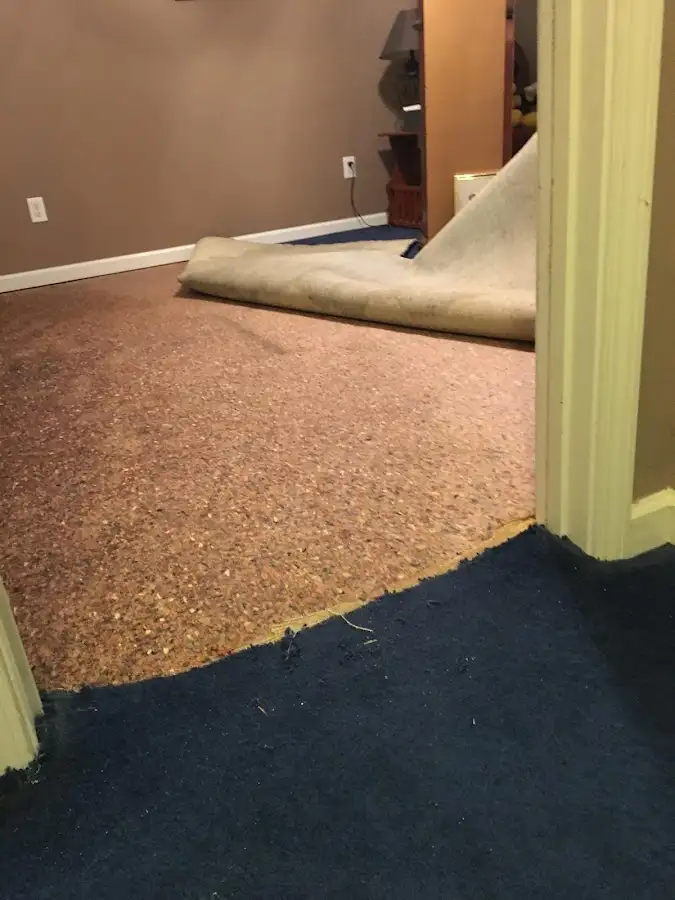 Carpet pad removal revealing water damage during Water Mitigation Services in Palm Desert